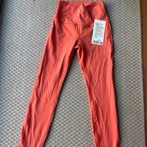 Lululemon leggings, size 4, new with tags. Tangerine color, winder under 28”
